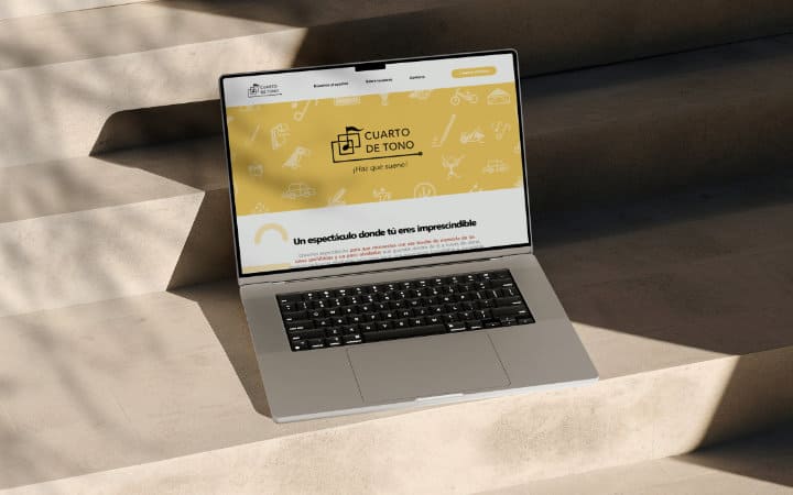 Laptop displaying the 'Cuarto de Tono' page with a yellow background.