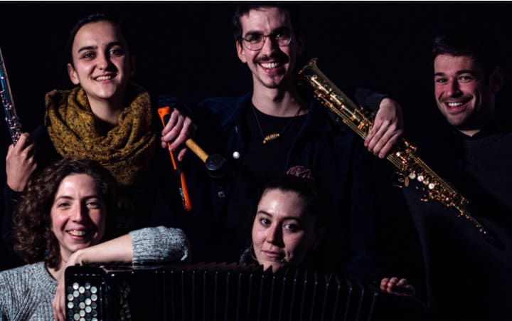 Several members of the Cuarto de Tono ensemble in dark tones.
